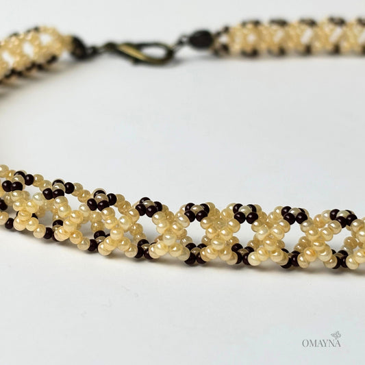 Mila necklace in brown and pearl - close-up