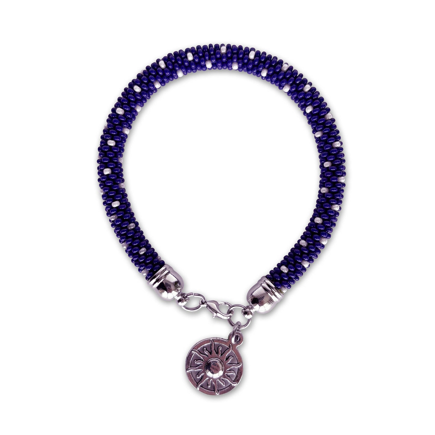Cobalt blue beaded bracelet with a silver charm on a white background