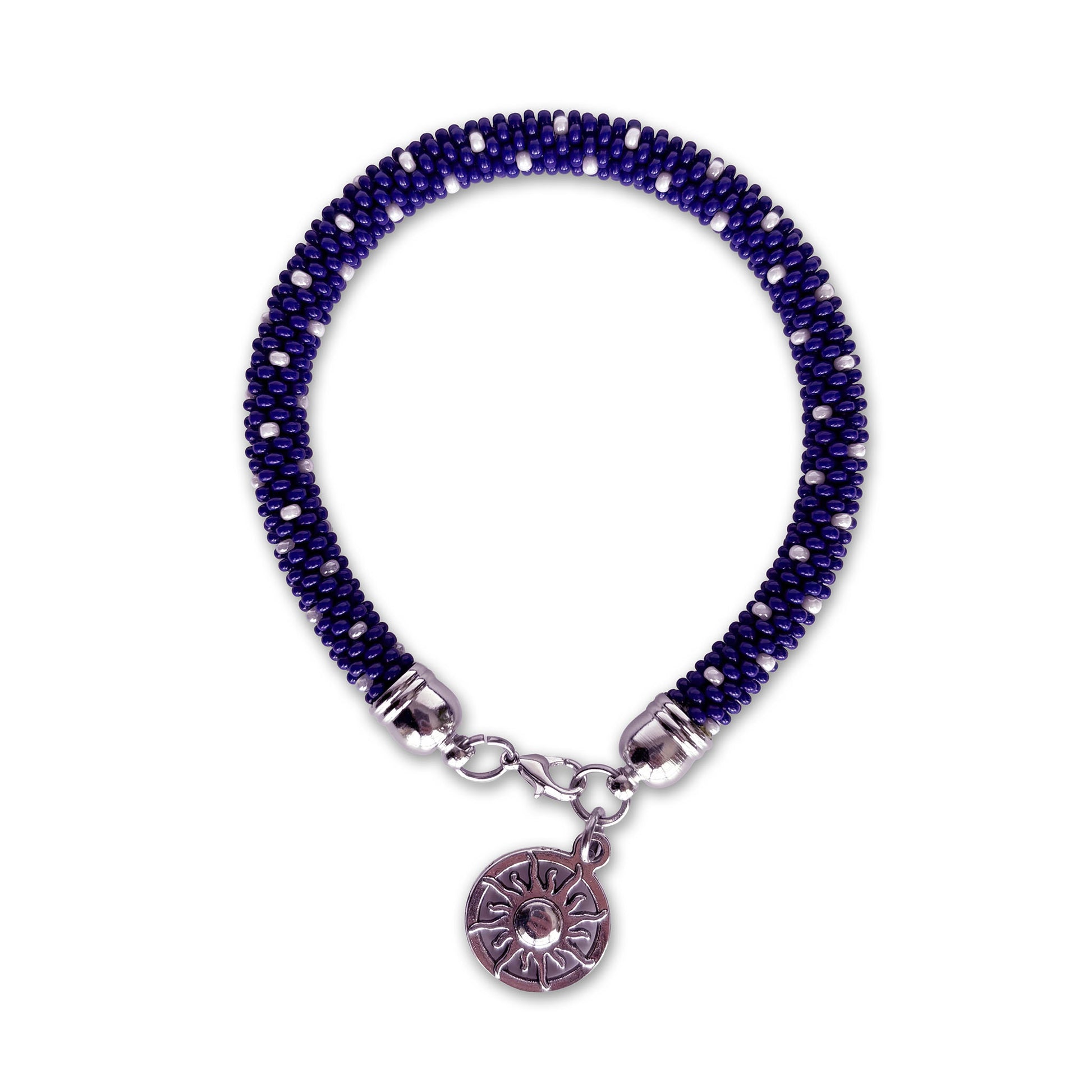 Cobalt blue beaded bracelet with a silver charm on a white background
