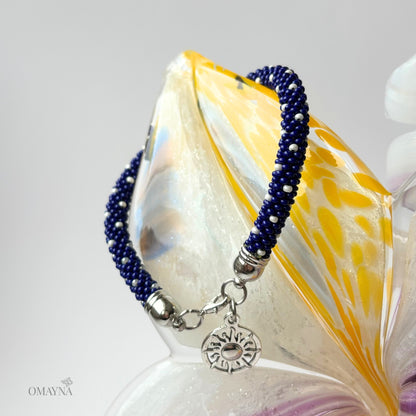 Cobalt bracelet with a sun charm on a decorative glass element