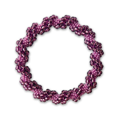 Purple and pink beaded bracelet on a white background