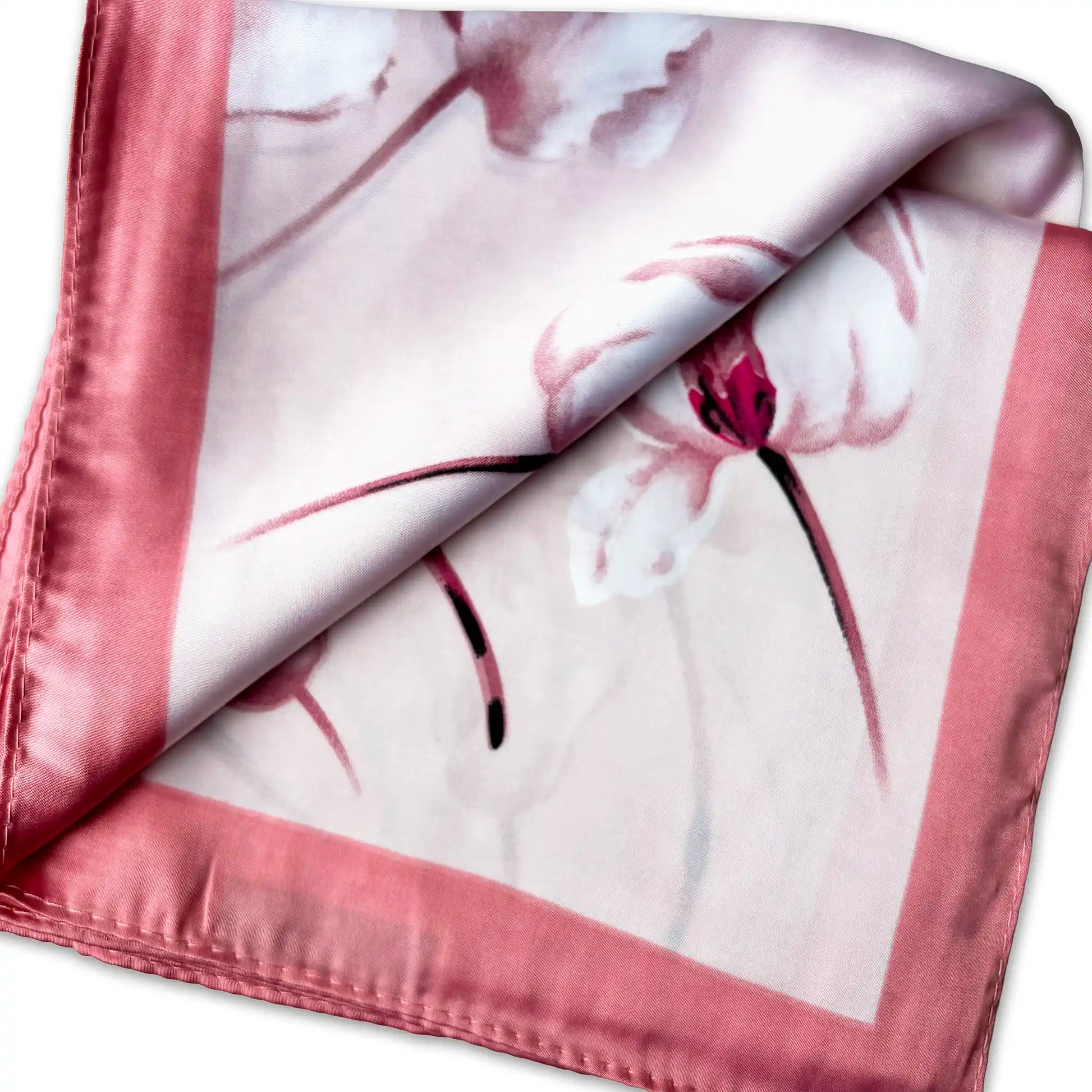 Floral patterned silk scarf with pink border on a white background