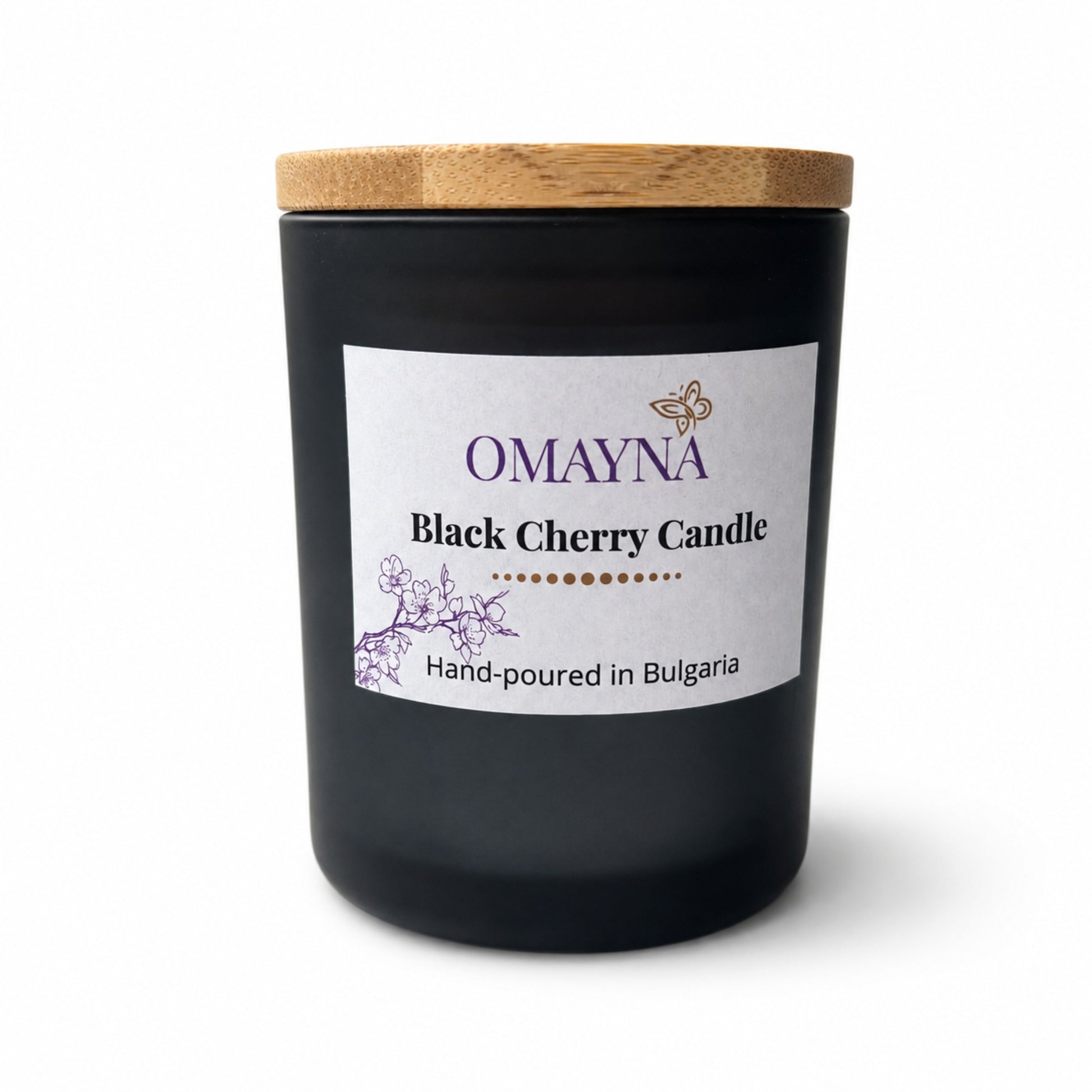 Black cherry candle with a wooden lid and Omayna label on a white background