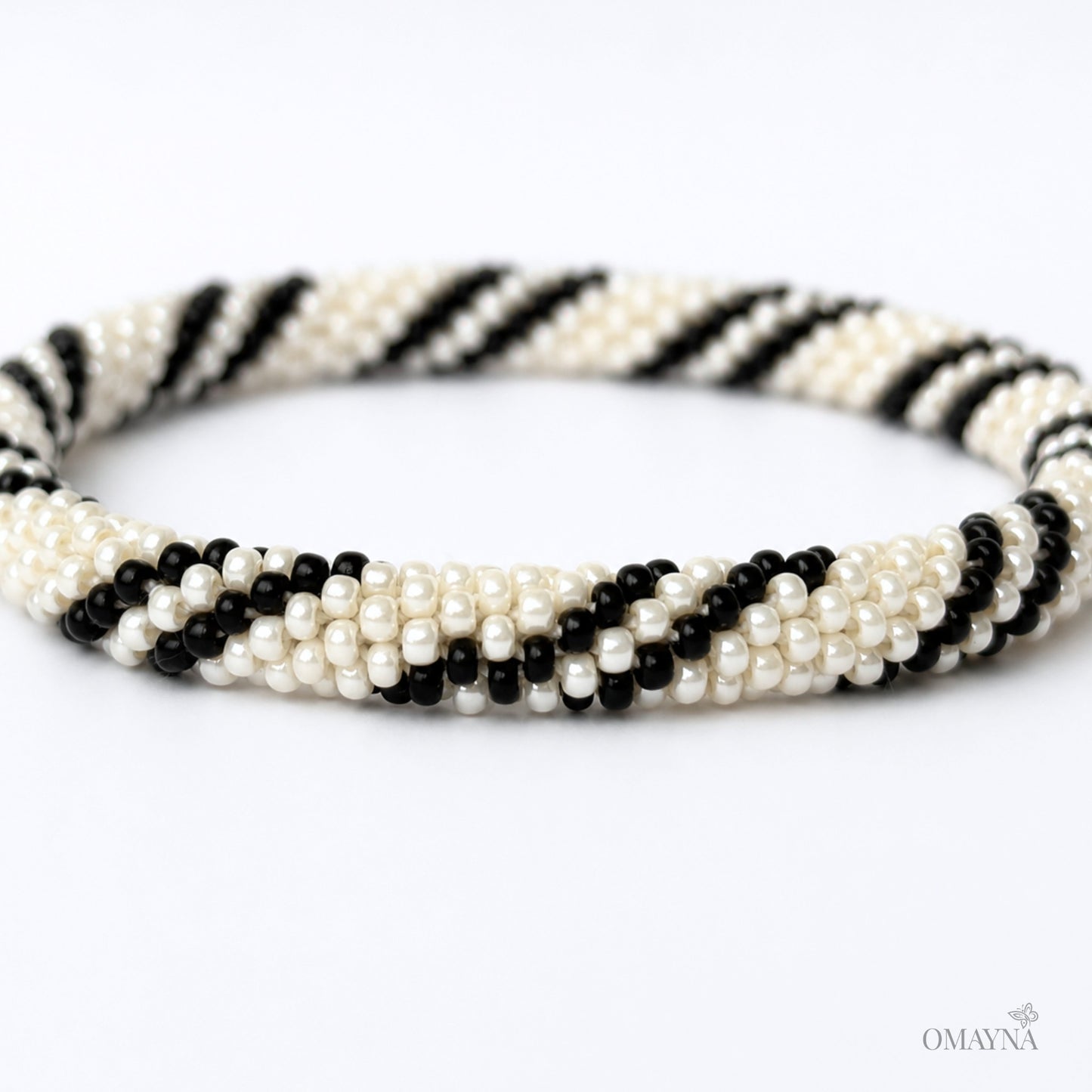 Black and pearl beaded bracelet on a white background