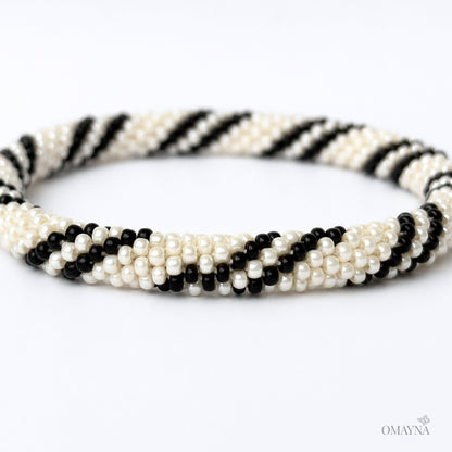 Black and pearl beaded bracelet on a white background