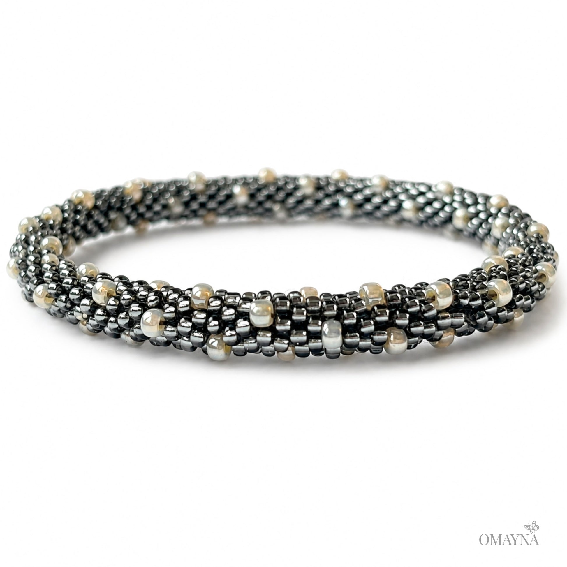 Multistrand beaded bracelet with metallic and pearl-like beads on a white background