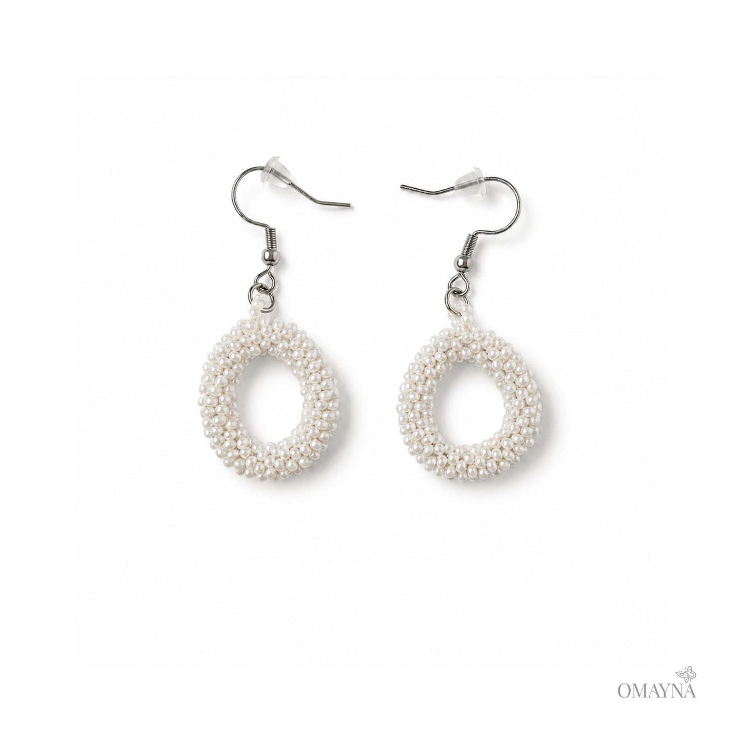 Pair of pearl earrings on a white background with 'OMAYNA' branding.