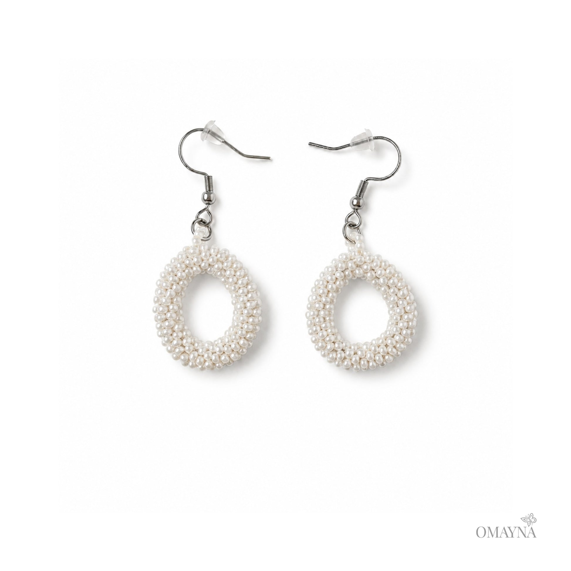 Pair of pearl earrings on a white background with 'OMAYNA' branding.