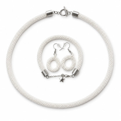 White beaded necklace with silver clasp and star charm, accompanied by matching earrings on a white background.