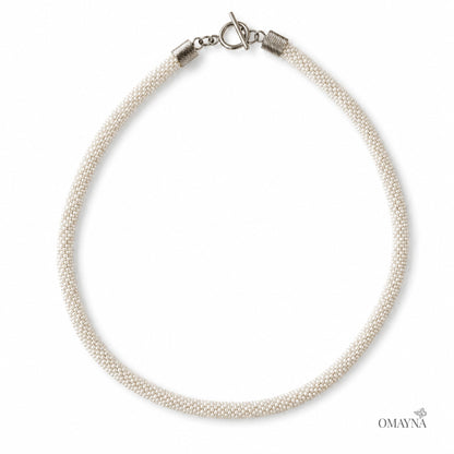 Pearl necklace with a silver clasp on a white background, branded 'OMAYNA'.