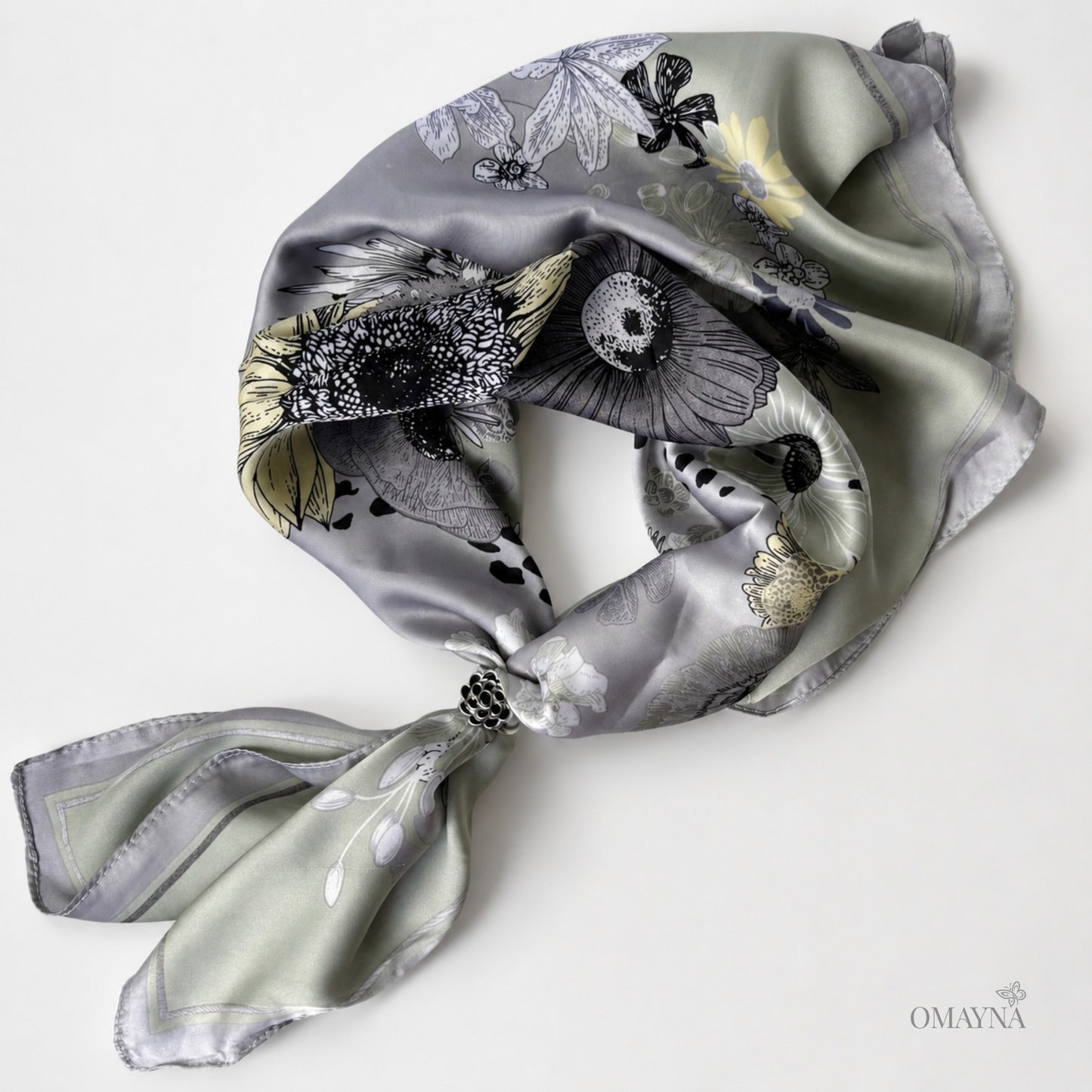 Decorative scarf with floral pattern and scarf ring on a white background, featuring the brand 'OMAYNA'.