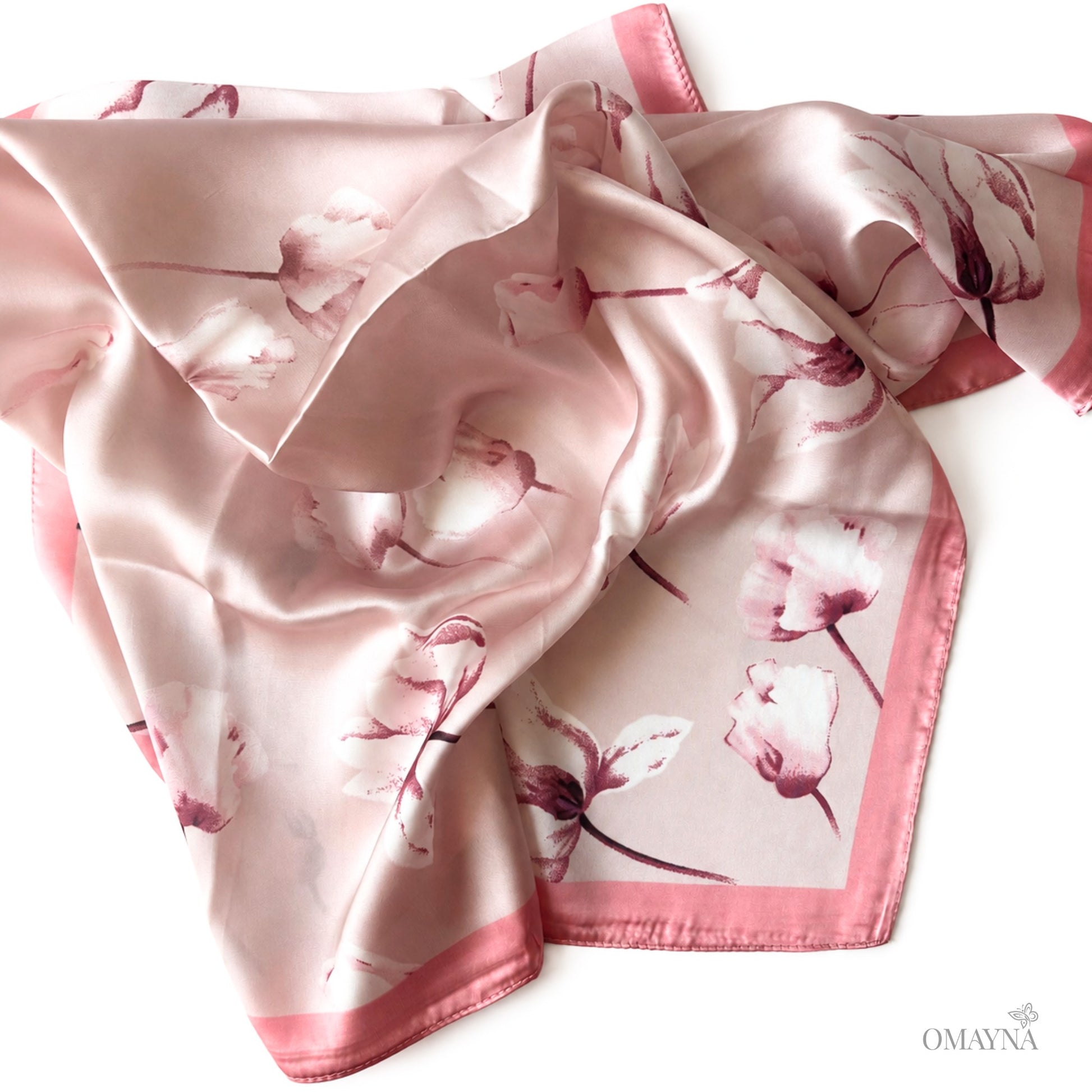 Floral patterned pink scarf on a white background