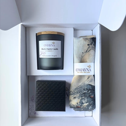 Gift set with a candle, silk scarf, and a black jewellery box in a white box.