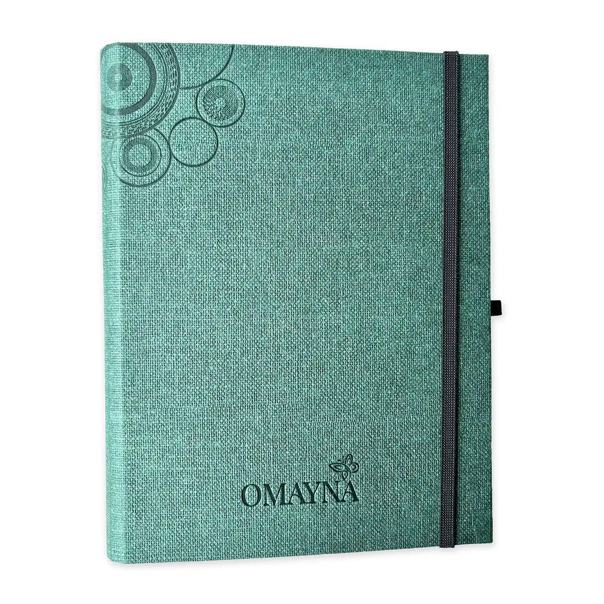 Green notebook with black strap closure on a white background with Omayna logo