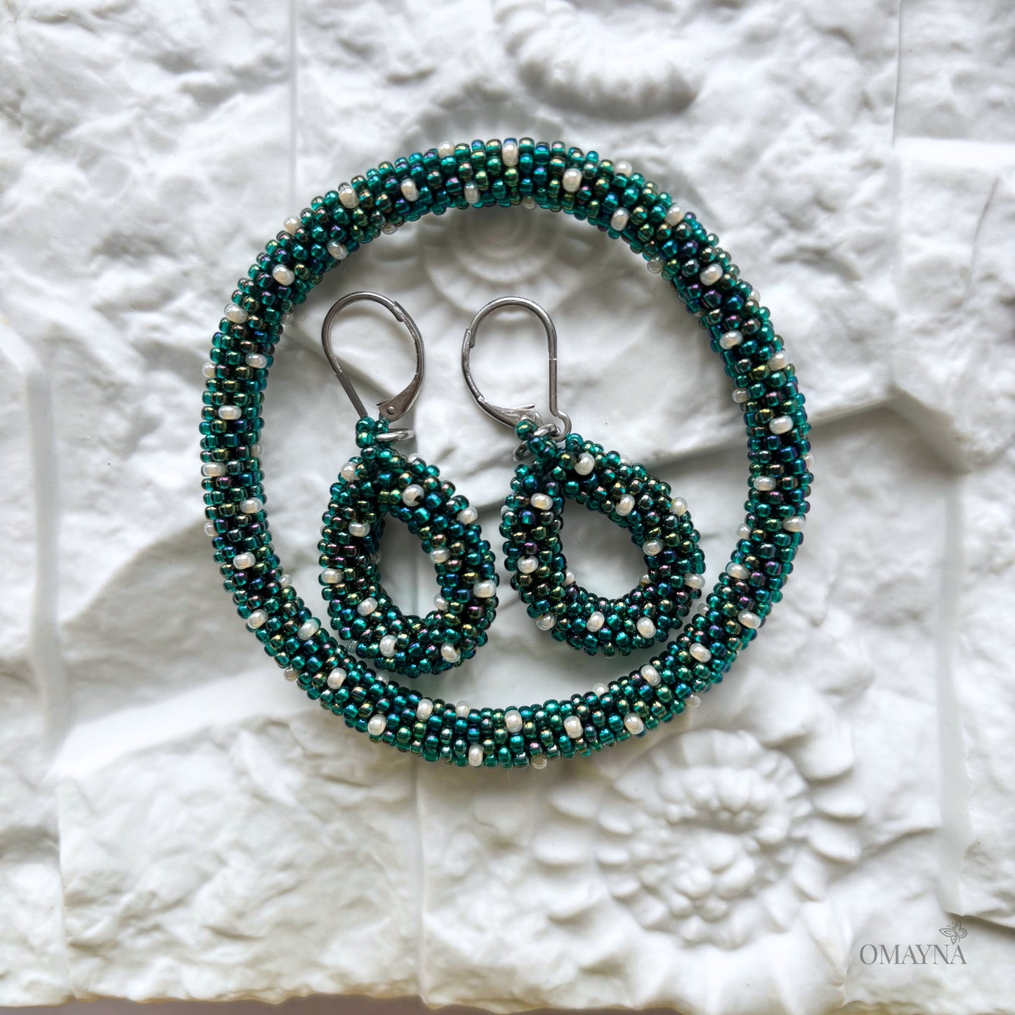 Teal beaded bracelet and earrings on a textured white surface - Ivy set | Omayna