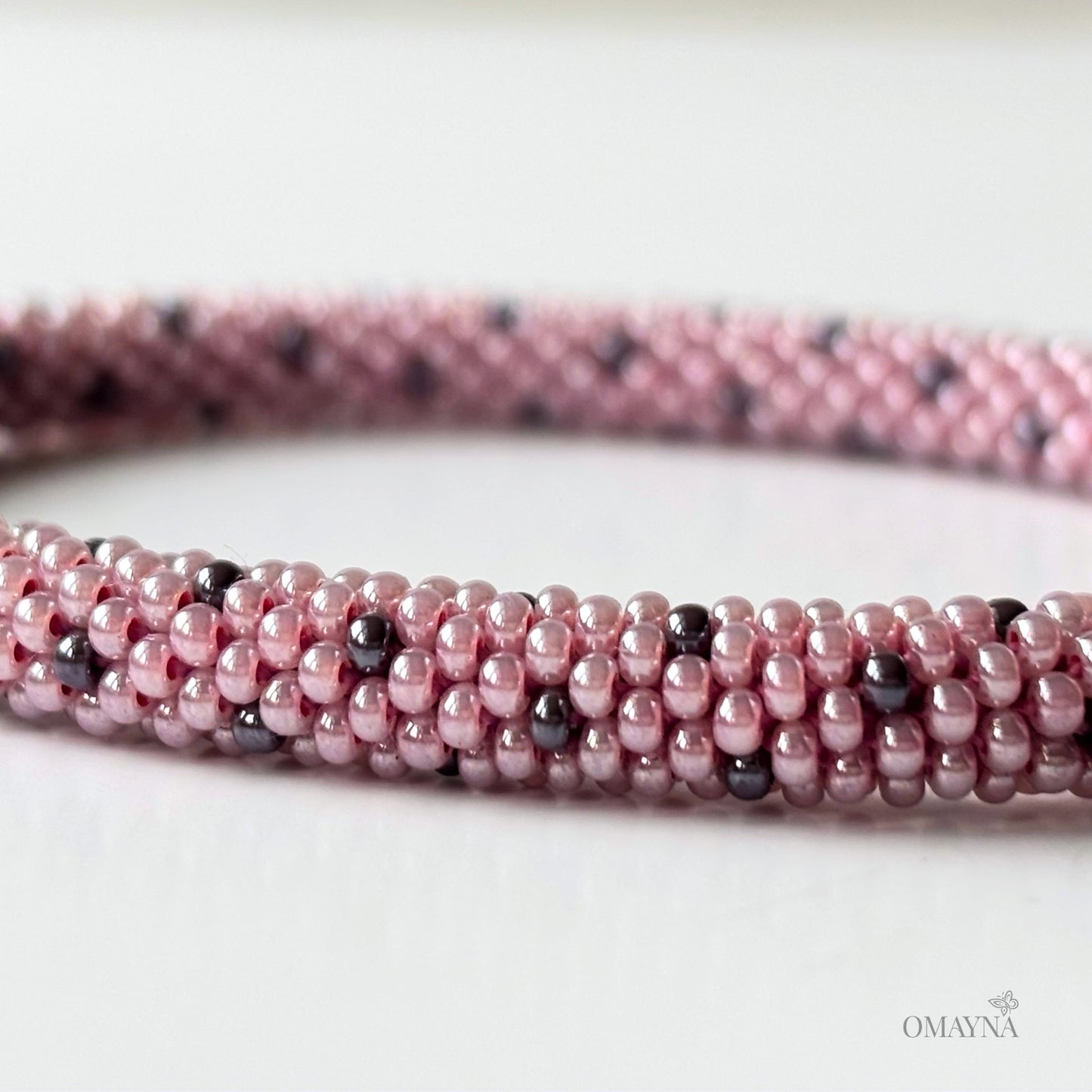 Lina beaded bracelet in soft pink tones with purple accents detail view