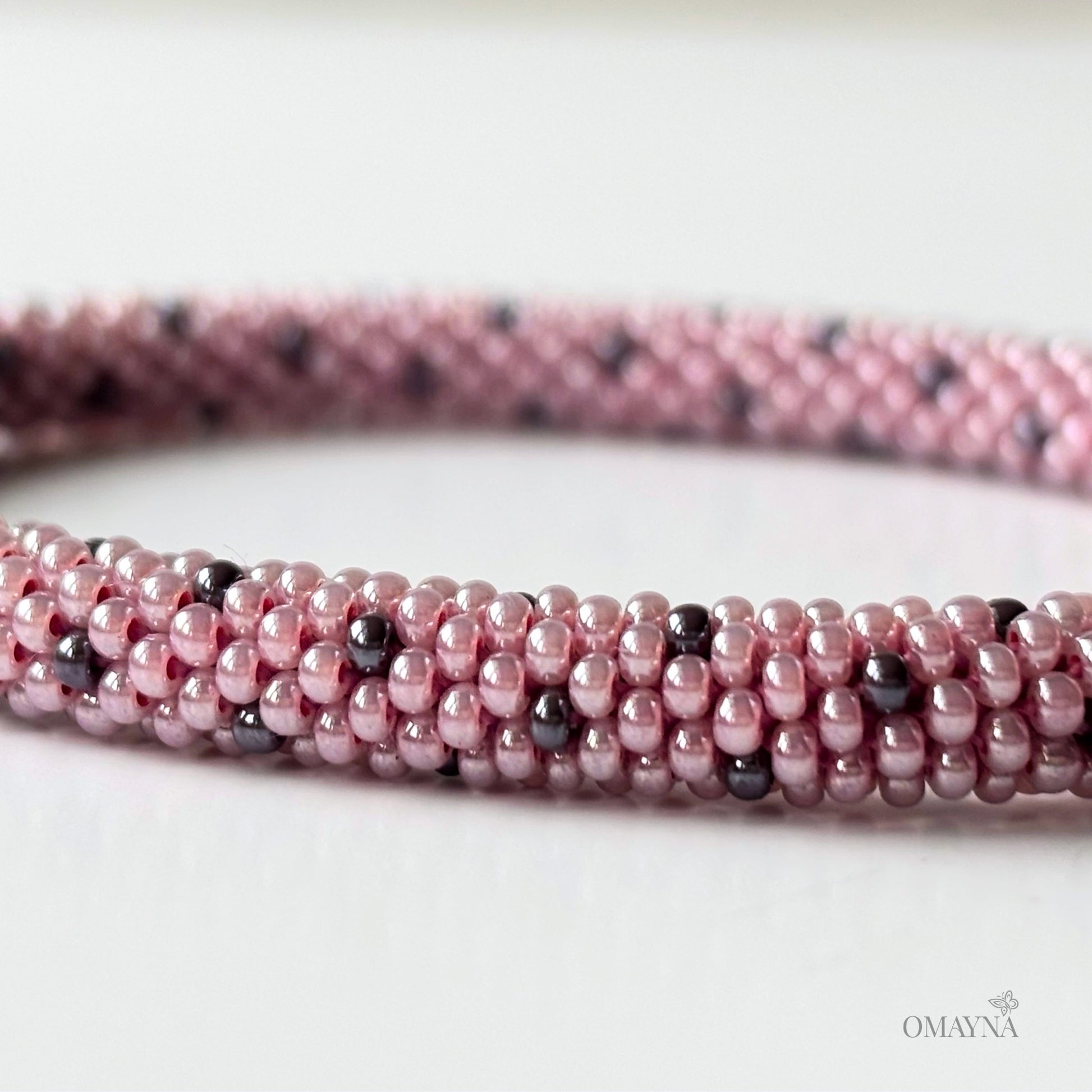 Lina beaded bracelet in soft pink tones with purple accents detail view