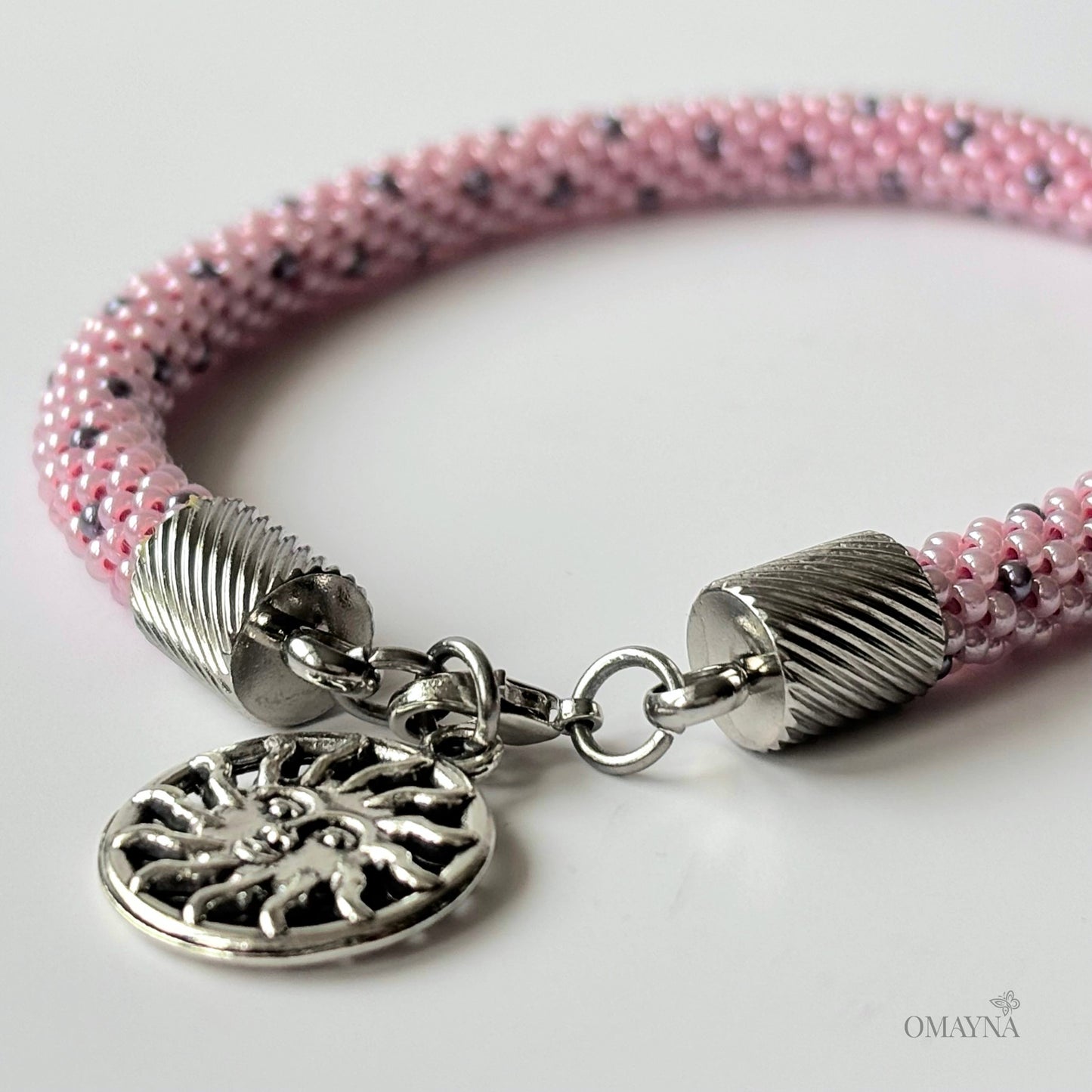 Lina Pink beaded bracelet with silver clasp and decorative charm detail view