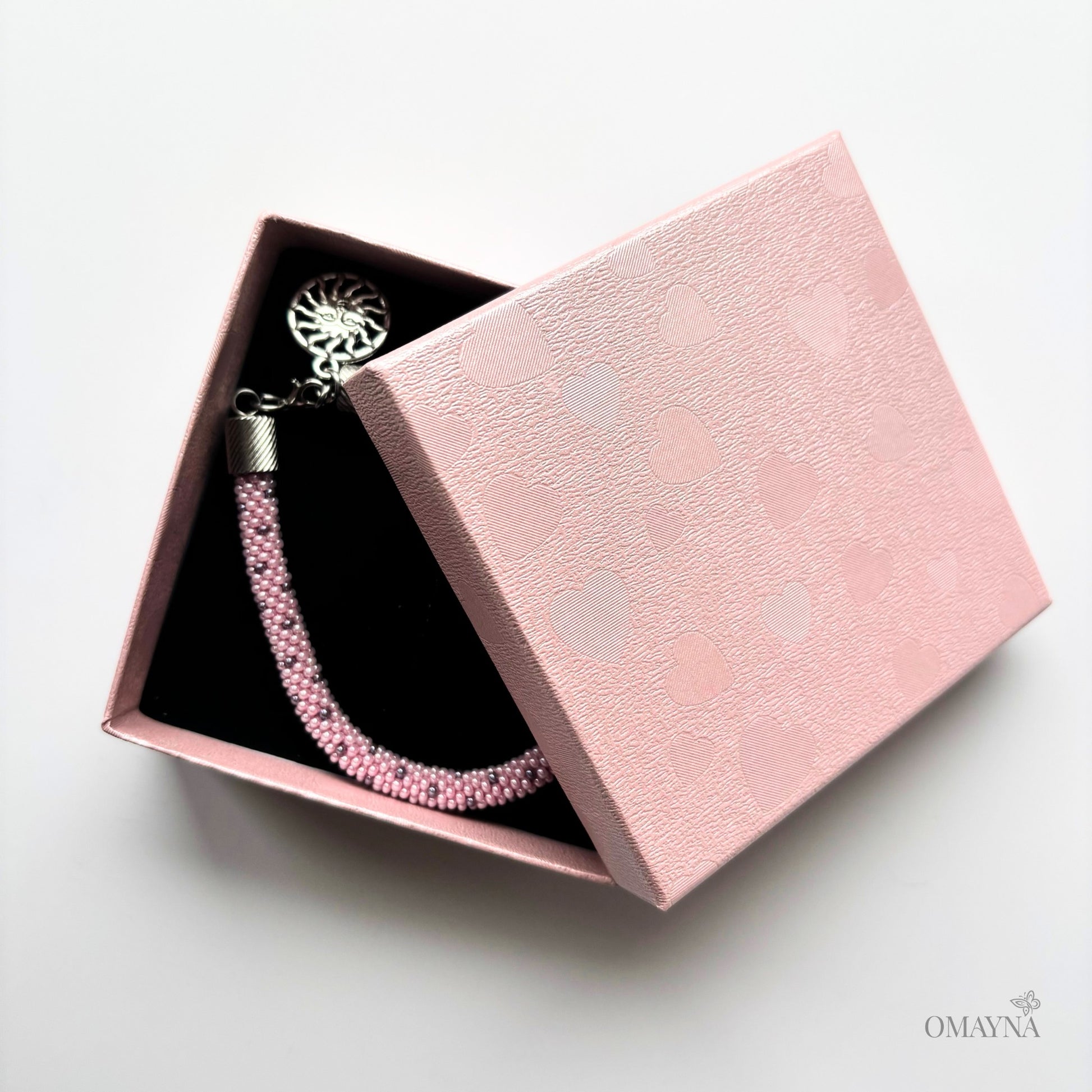 Lina pink beaded bracelet in a pink jewellery box on a light grey background