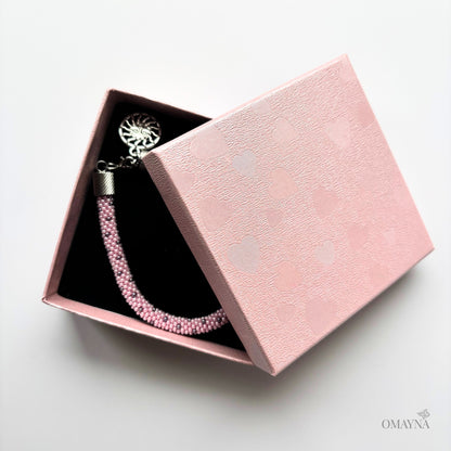 Lina pink beaded bracelet in a pink jewellery box on a light grey background