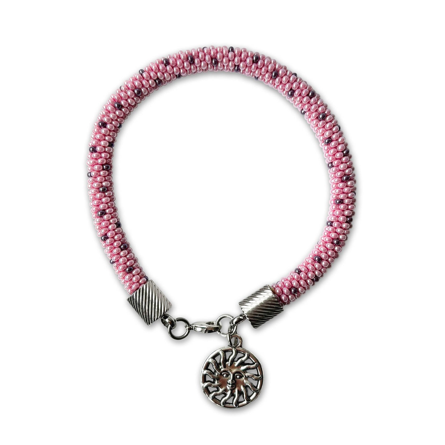 Lina beaded bracelet in soft pink tones with purple accents and sun charm on a white background