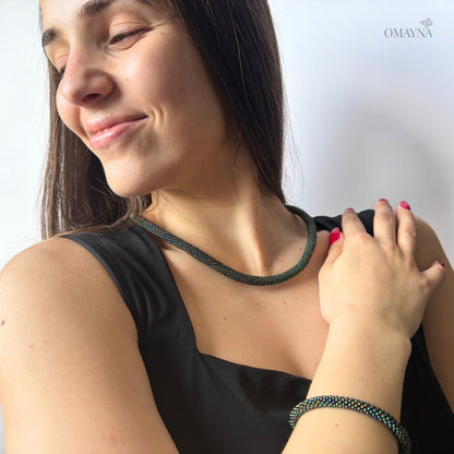 Woman wearing a green beaded necklace and bracelet, colour green iris