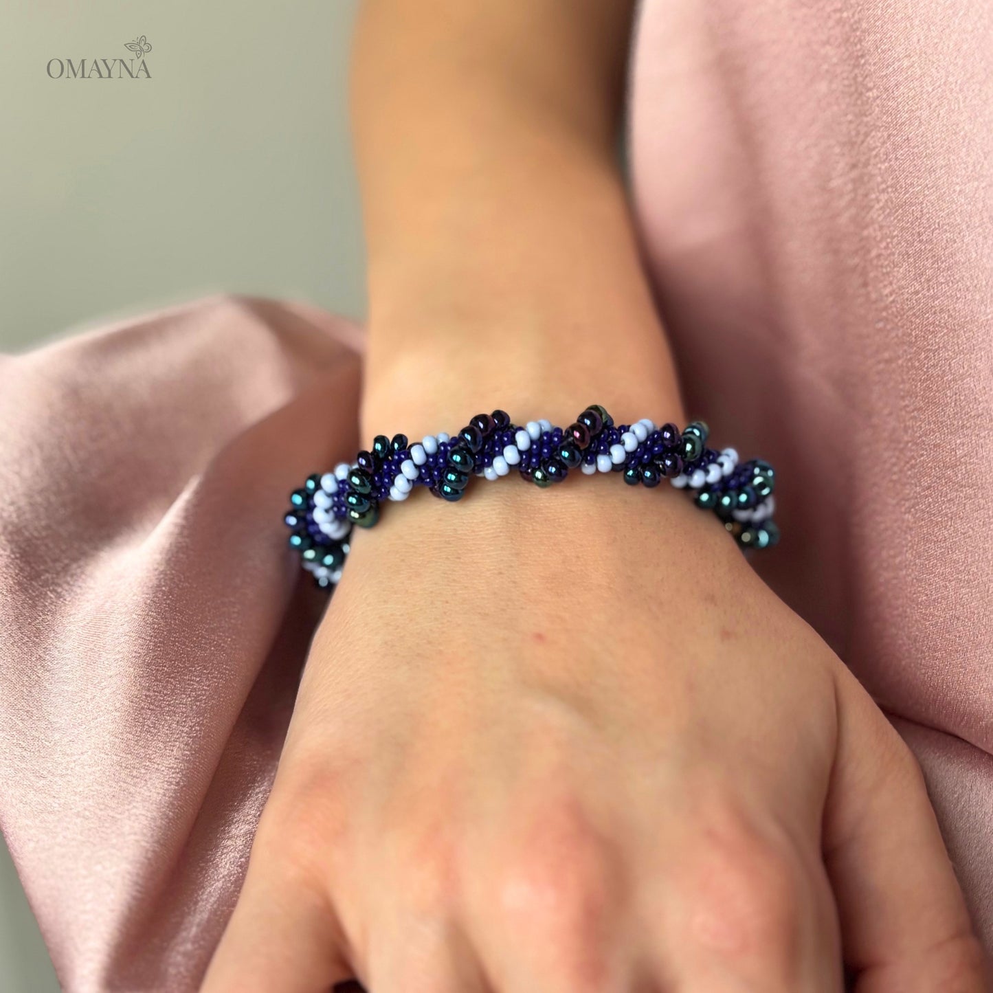 Mia beaded bracelet in purple and blue tones worn on wrist