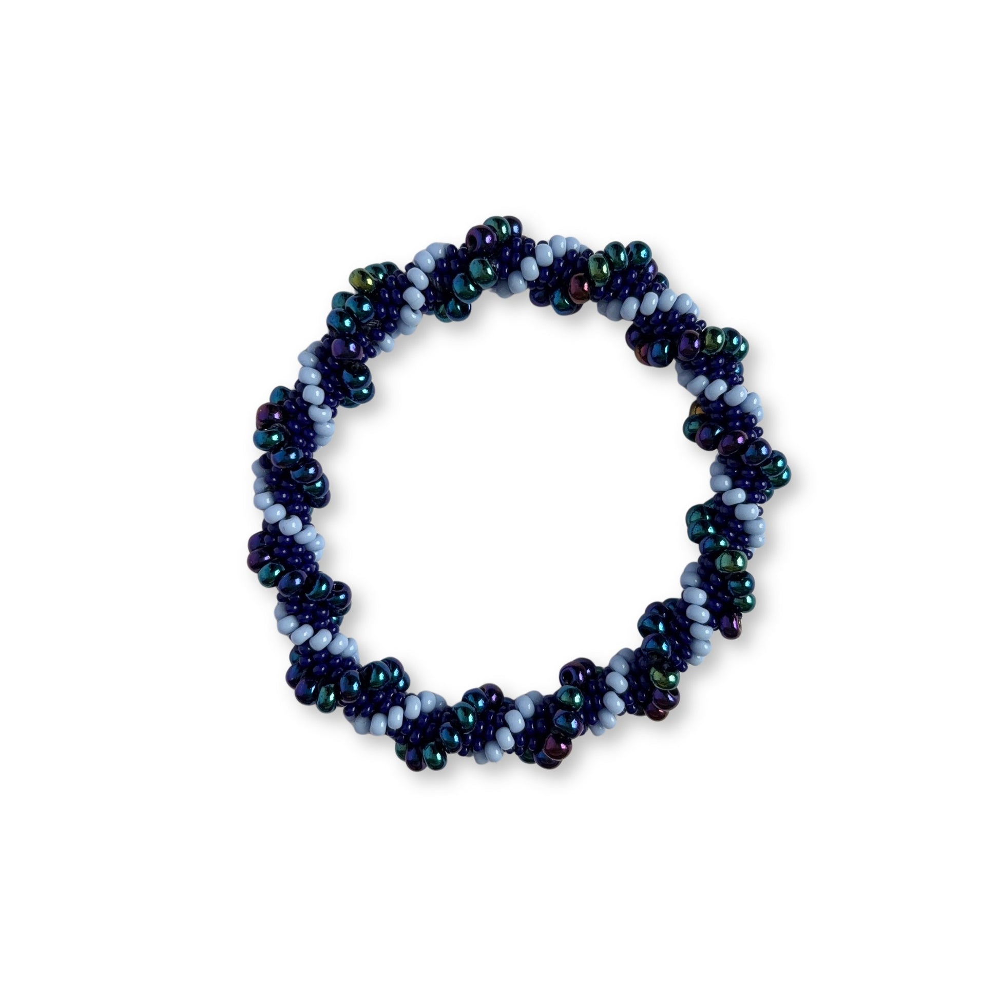 Beaded bracelet with different shades of purple beads on a white background