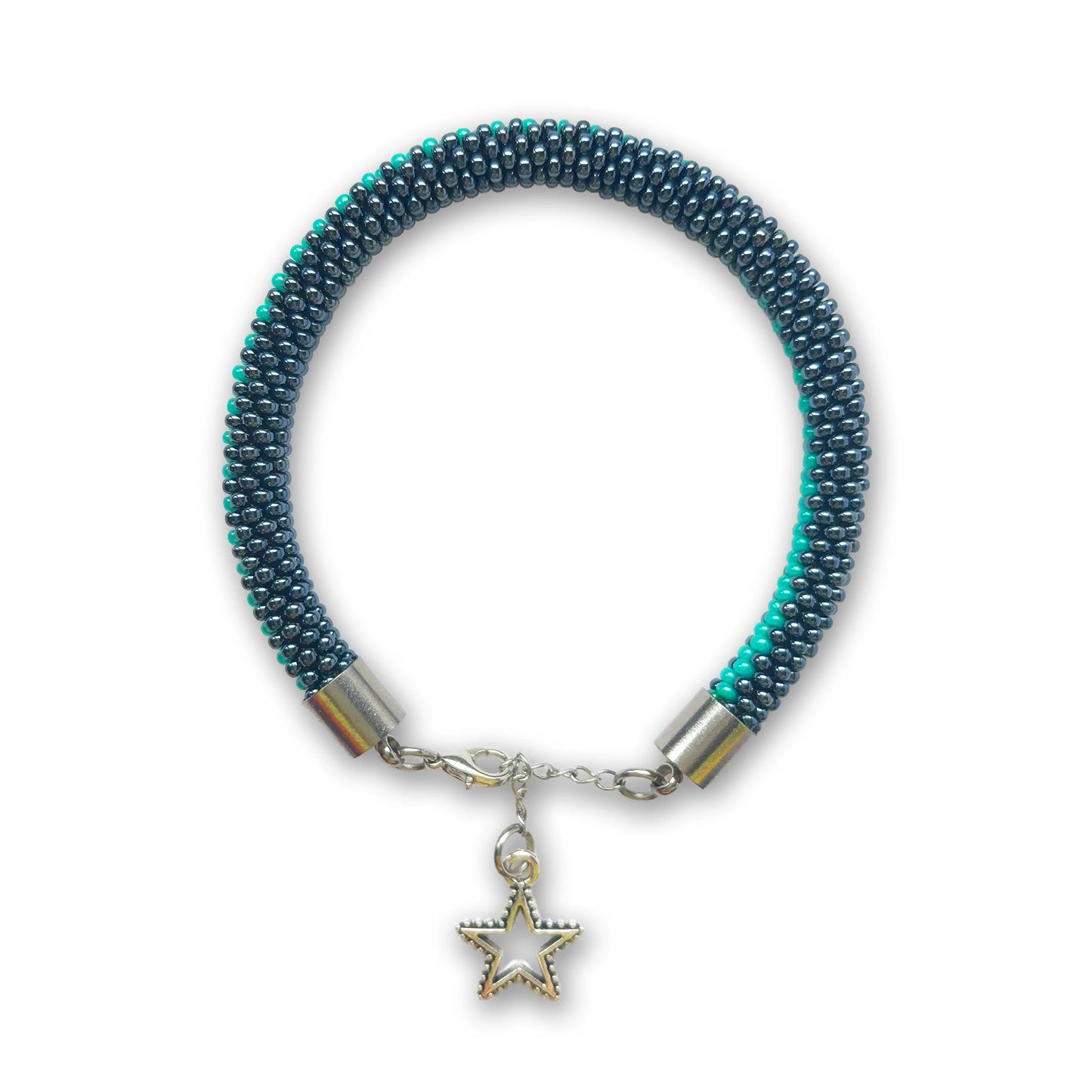Hematite and green beaded bracelet with a star charm on a white background