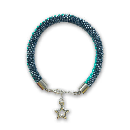 Hematite and green beaded bracelet with a star charm on a white background