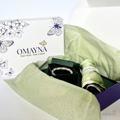 OMAYNA jewelry set with a box and green tissue paper on a white background