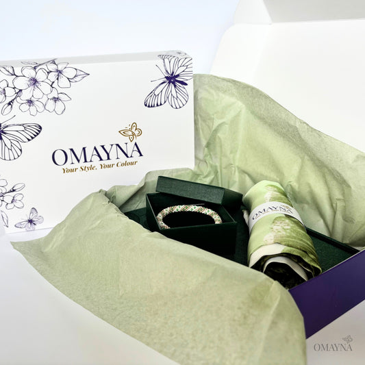 OMAYNA jewelry set with a box and green tissue paper on a white background