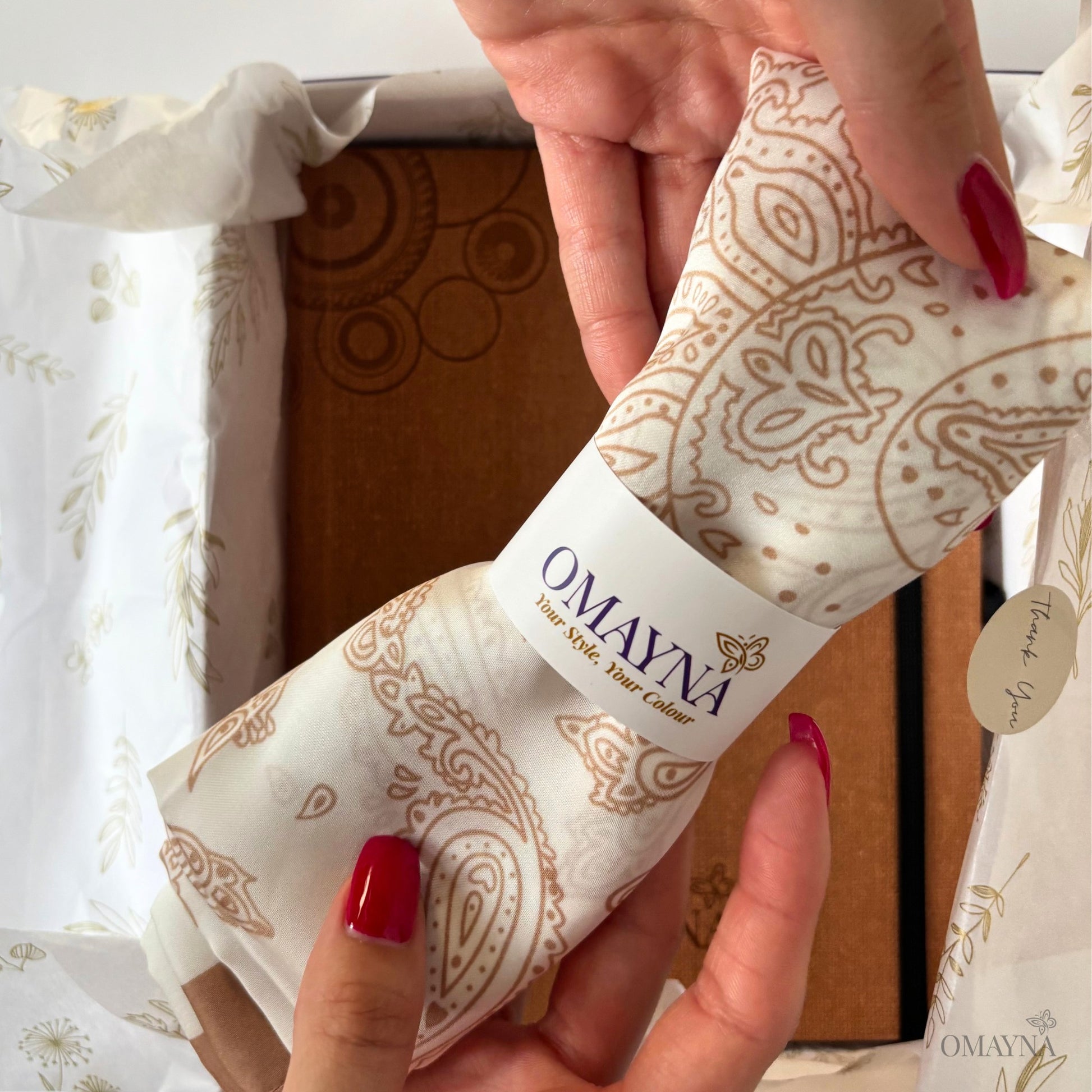 Scarf from the Notebook set Ivory & Brown | Omayna, held by hands with red nail polish.