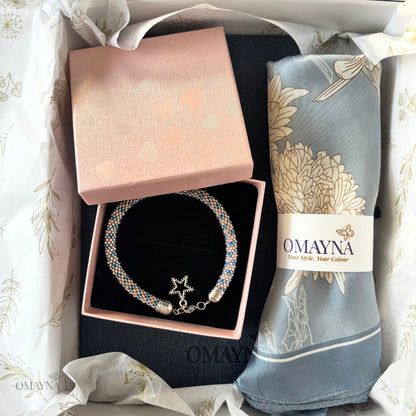 Bracelet and silk scarf with 'Omayna' branding in a gift box.