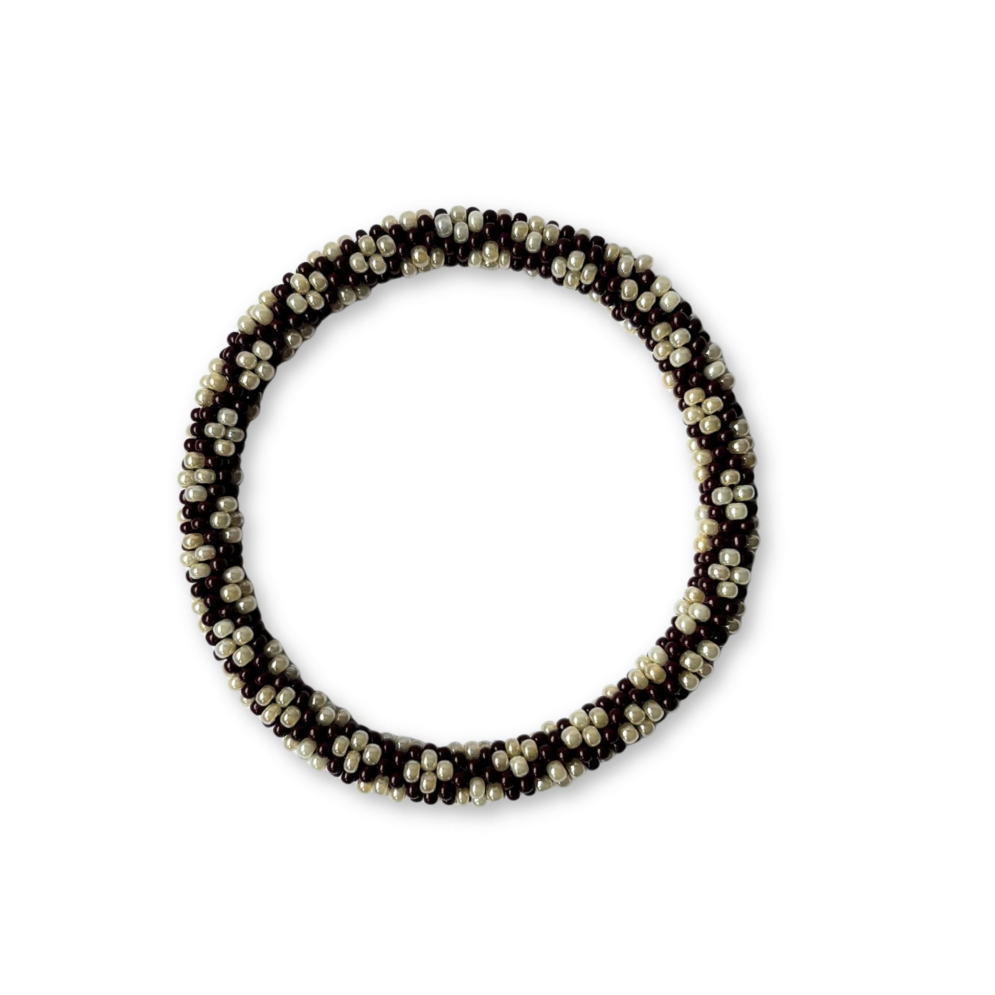 Beaded bracelet with alternating brown and beige beads on a white background