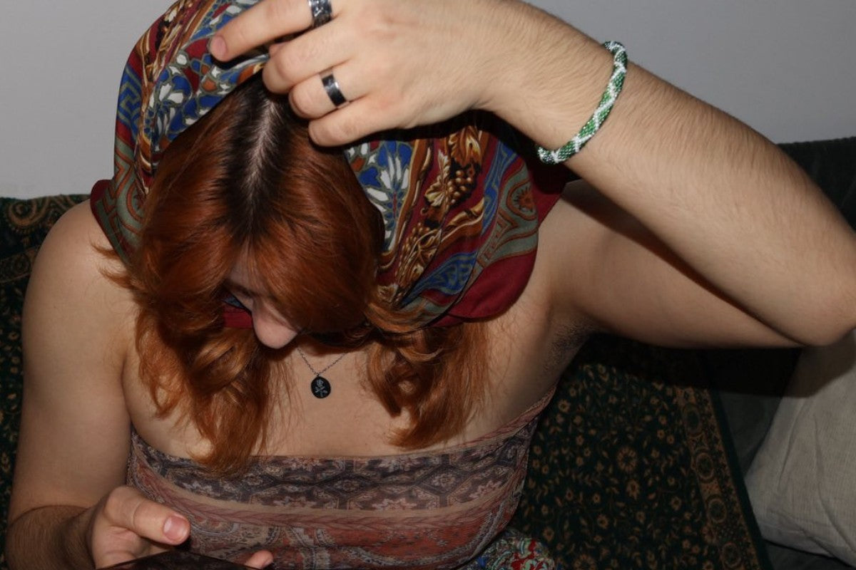 Young girl wearing Omayna bracelet in green and white