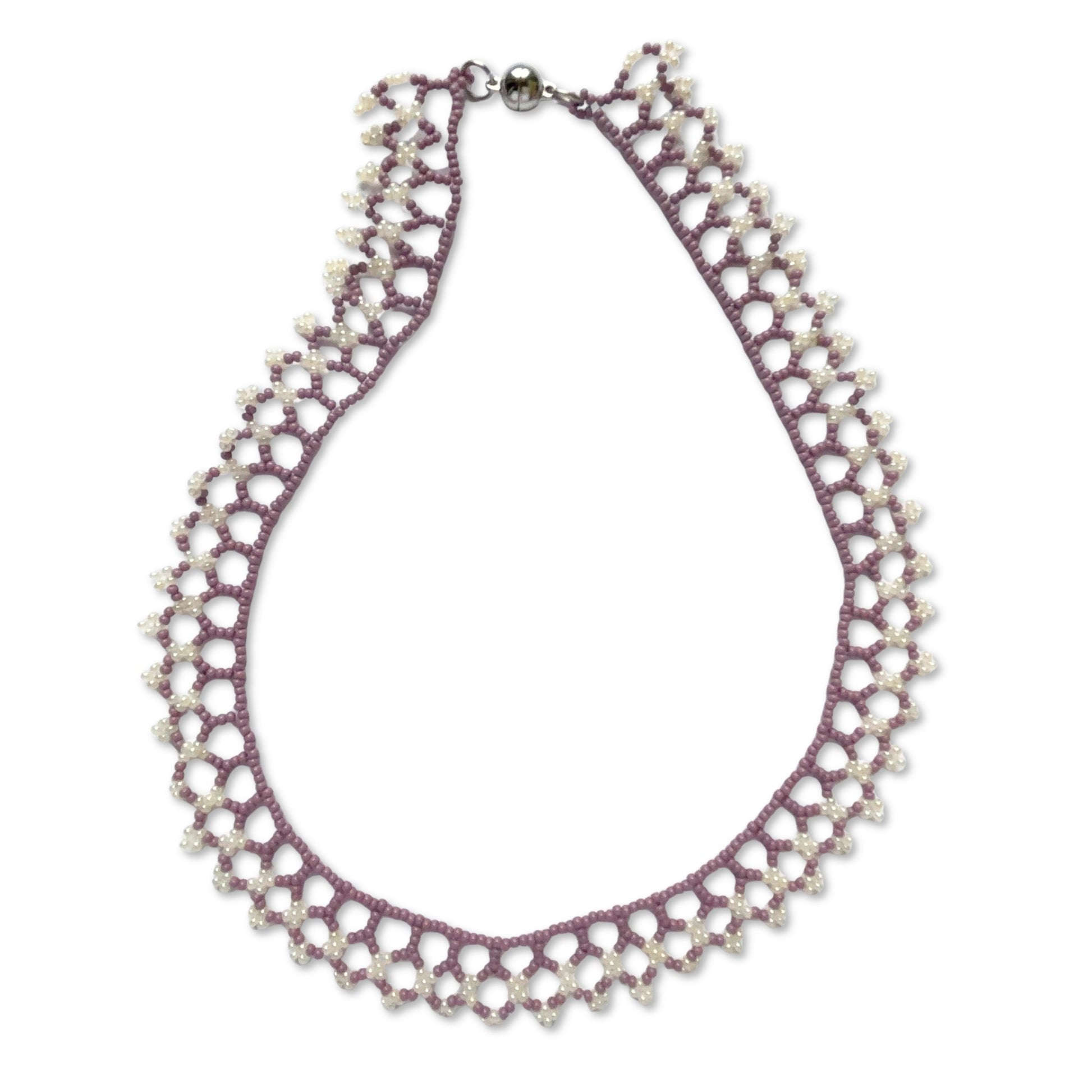 Una beaded necklace in soft purple and cream tones on a white background
