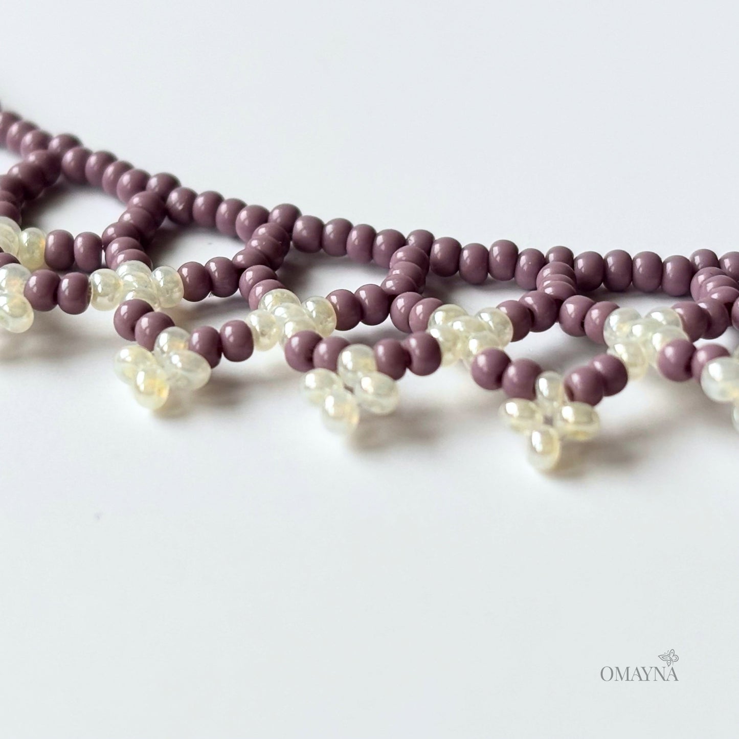 Una beaded necklace in soft purple and cream tones - details