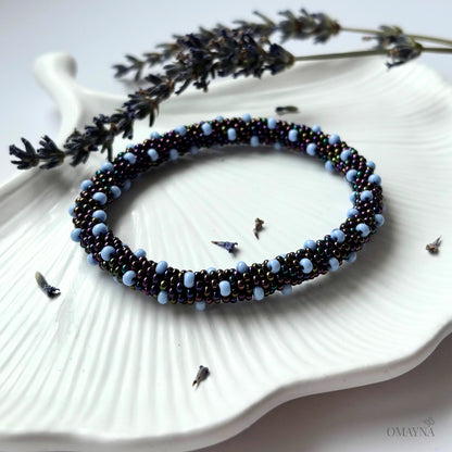 Vera bracelet in blue tones on a jewellery tray with lavender