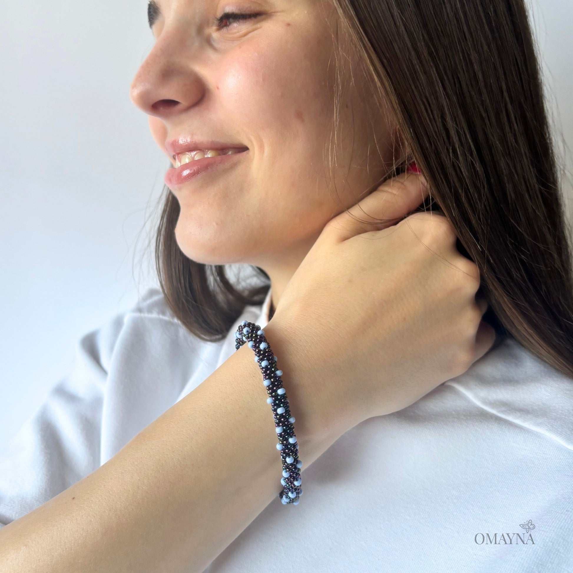 Bracelet in light blue & shades of blue on a young woman hand