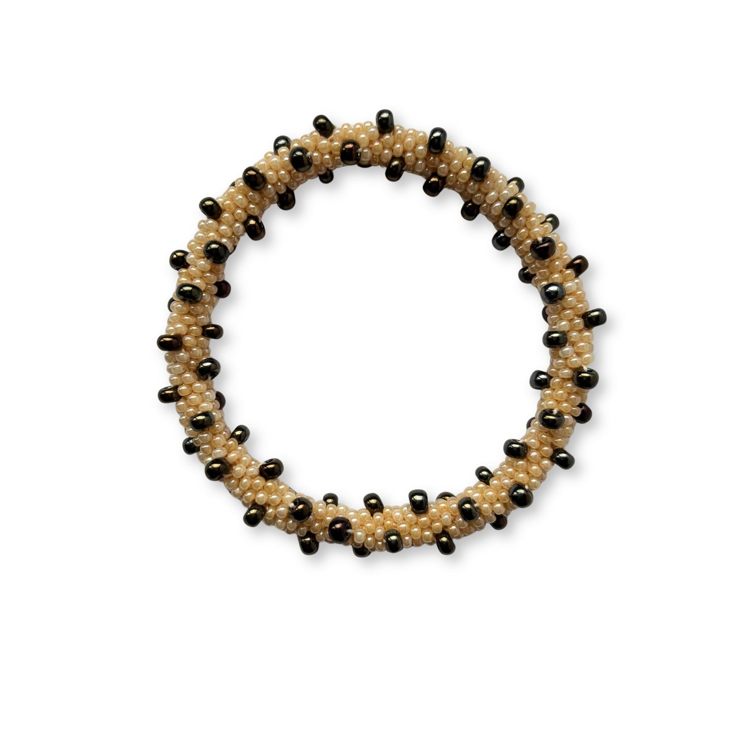 Beaded bracelet with alternating brown and beige beads on a white background