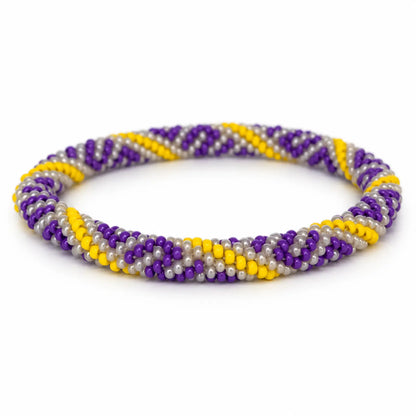 Handmade beaded bracelet in purple, yellow and pearly white on a white background.