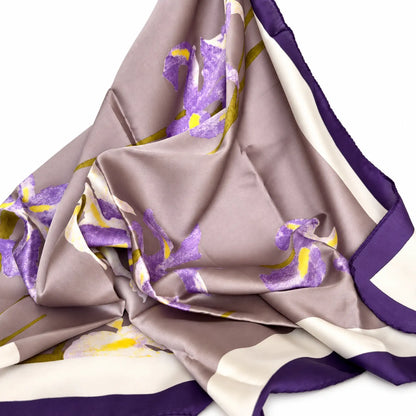 Floral scarf with purple flowers, yellow accents and a dark purple border.